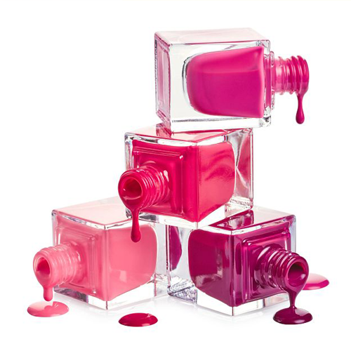 glass polish containers on their sides dripping shades of pink and purple